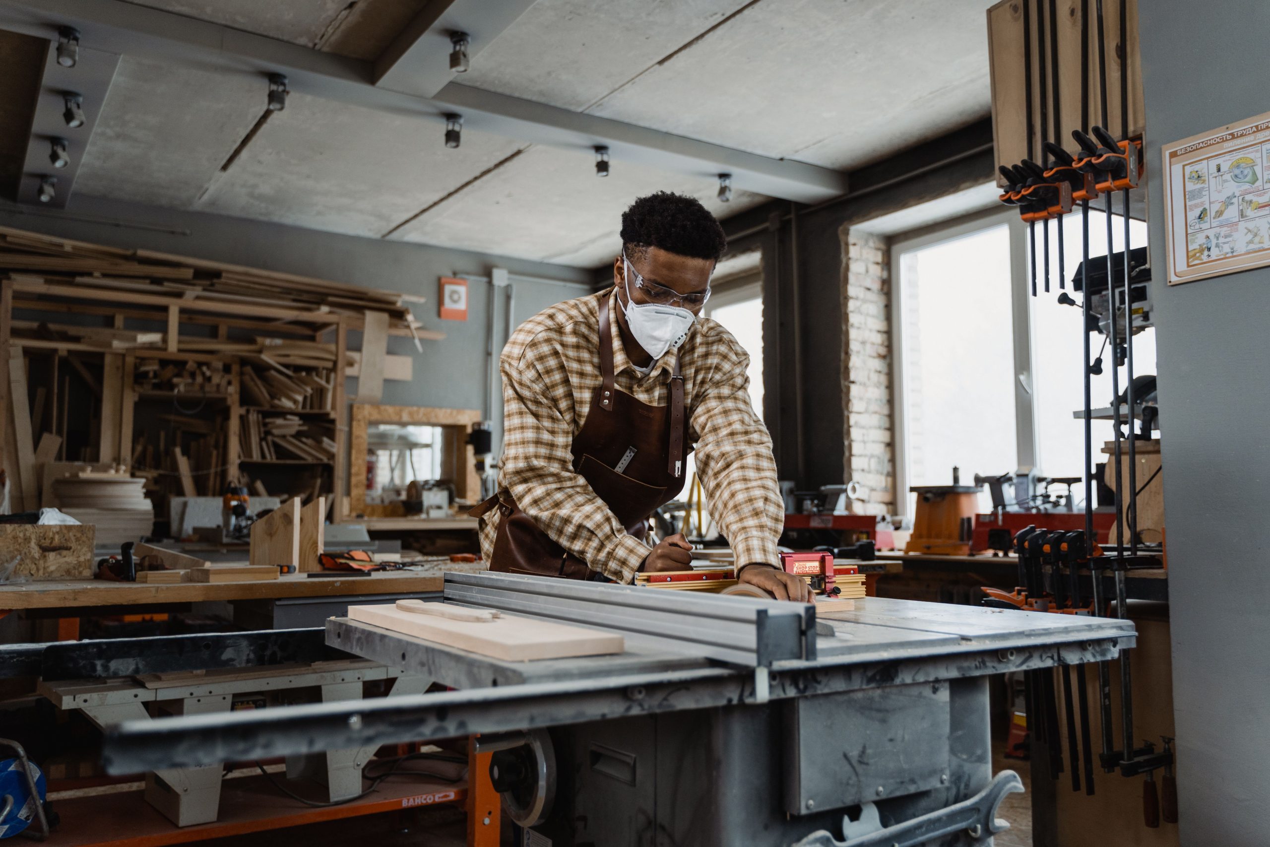 A woodworker crafting custom timber pieces on a table saw, reflecting modern commercial joinery trends.